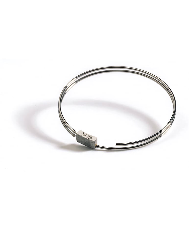 A coiled steel gong spring with its small fixing block