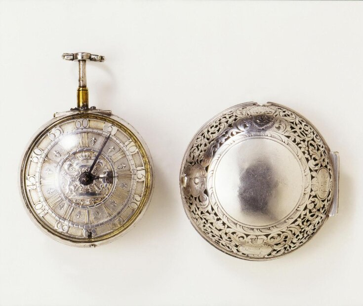 A silver repeating watch by Daniel Quare of about 1700, with its pierced outer case beside it